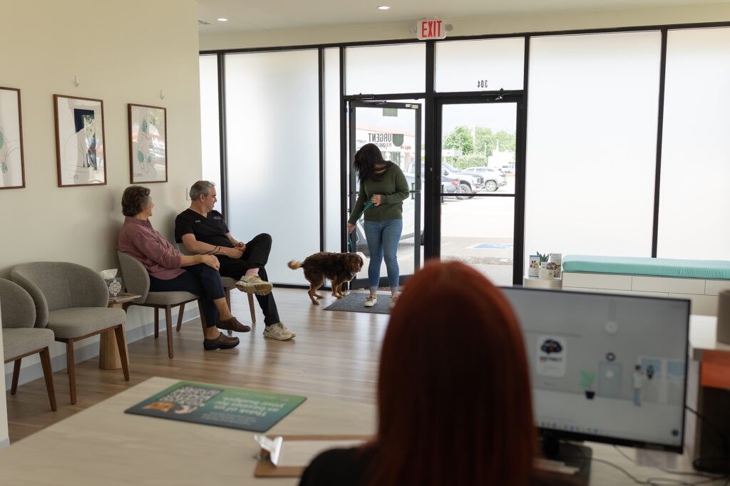 Pet owners and staff inside Urgent Vet in OKC, the trusted after-hours vet in Oklahoma City providing compassionate, same-day urgent pet care.